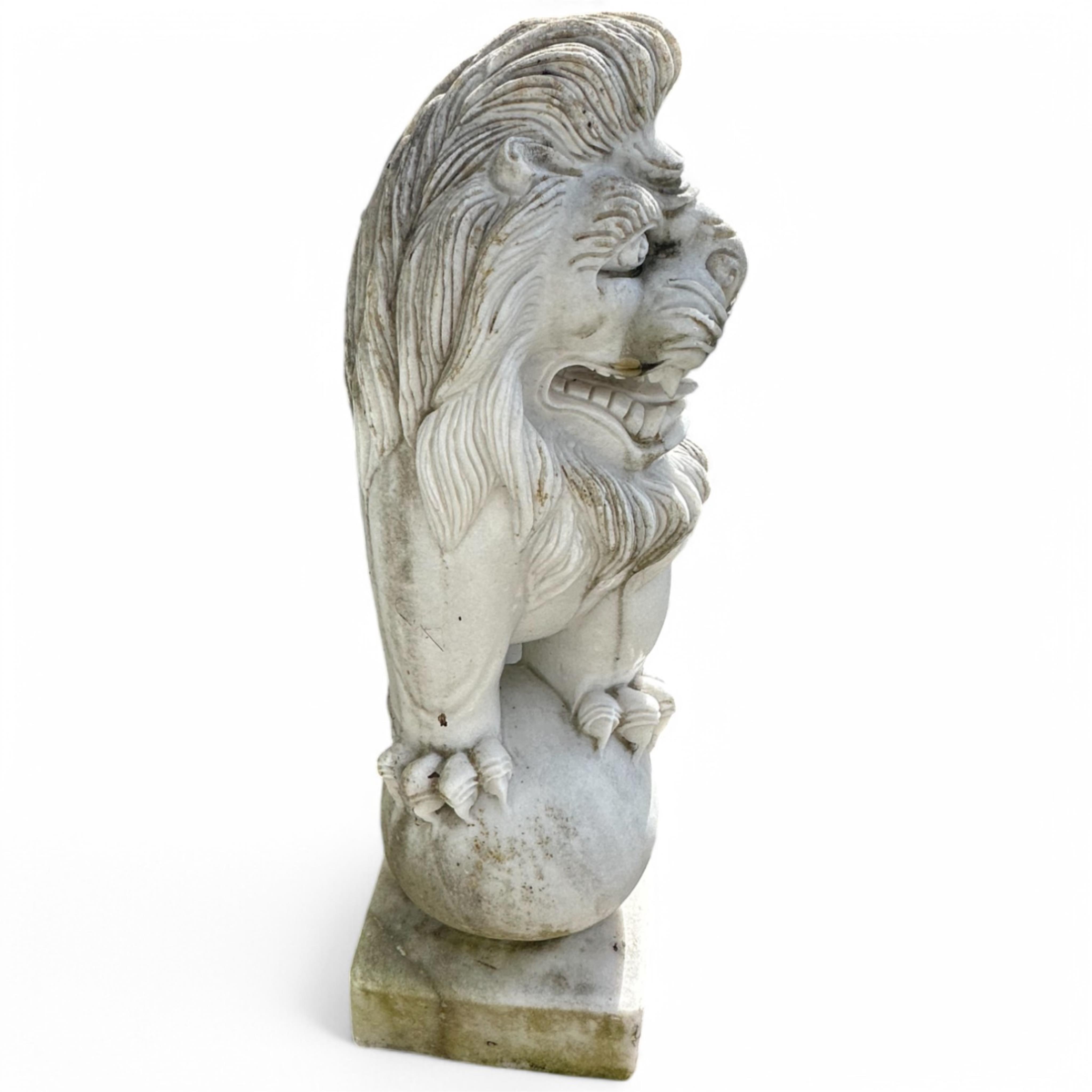 A pair of reconstituted white marble models of lions rampant